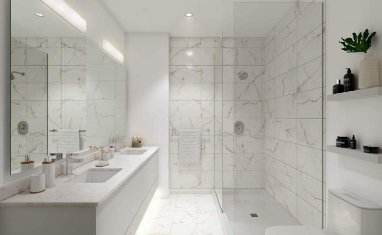 Frameless glass shower with large-format porcelain tile shower surround.