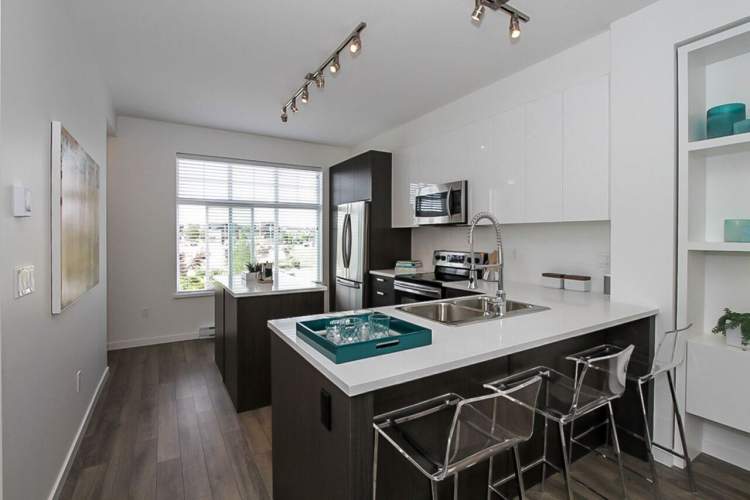 Open-island, oversized kitchens include imported quartz countertops and premium stainless steel appliances.