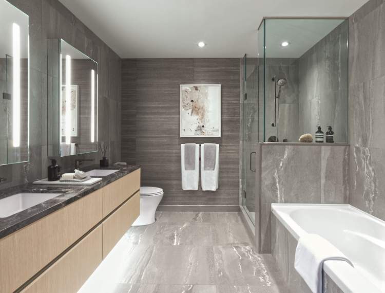 An exquisite sanctuary with a frameless glass shower or deep soaker tub equipped with Kohler accessories.
