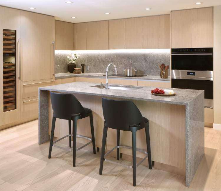 Iconic Sub-Zero and Wolf appliances seamlessly integrate with the neutral toned kitchen cabinetry.