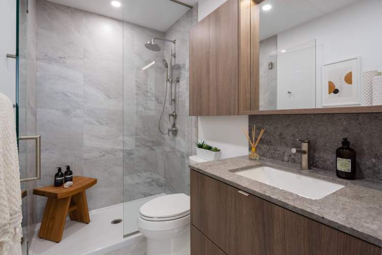 Boasts a spacious walk-in shower with luxurious glass enclosure.
