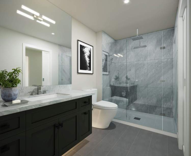 Elegant en suites with custom glass shower enclosures and oversized porcelain tile.