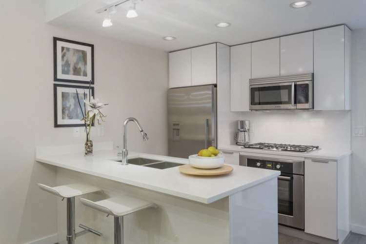 Premium stainless steel appliances and designer cabinetry with Blumotion hardware.