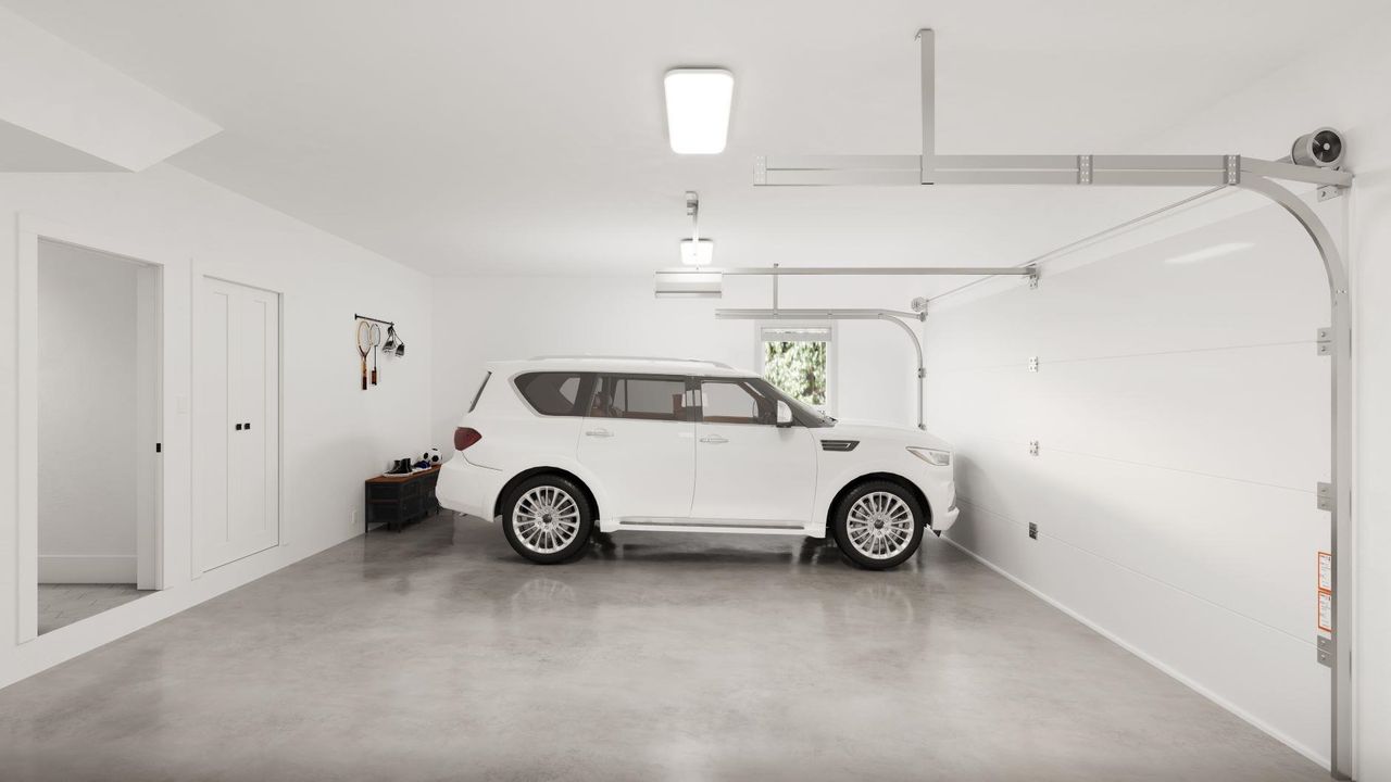 Spacious garage for two cars, side-by-side, with plenty of room for storage.
