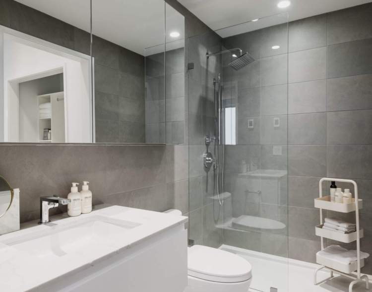 Fully-tiled bathroom in Timeless White colour scheme.