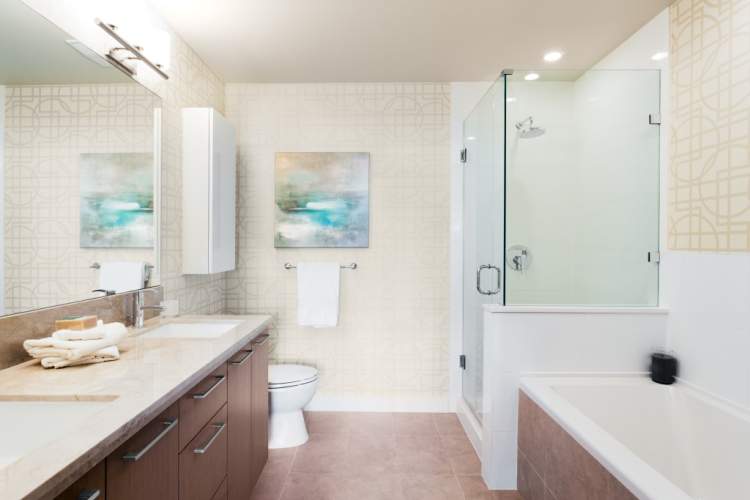Opulent Bathrooms at Riva Richmond - Stone countertops, oversized tiles, and a deep soaker tub complete the luxe look.