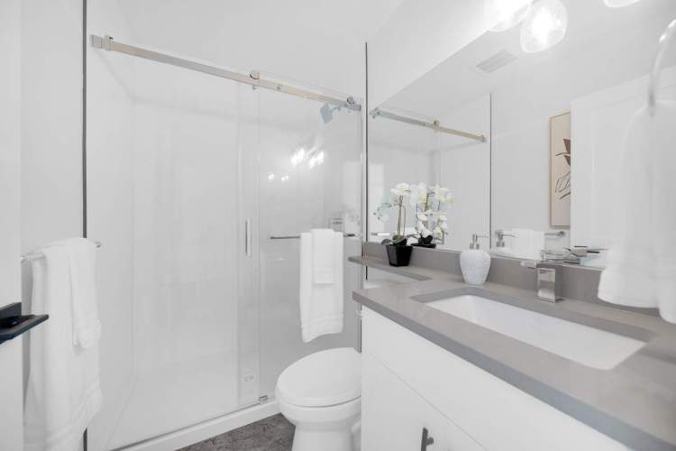 Bathrooms feature a frameless shower surround and 12" x 24" wall tiles.