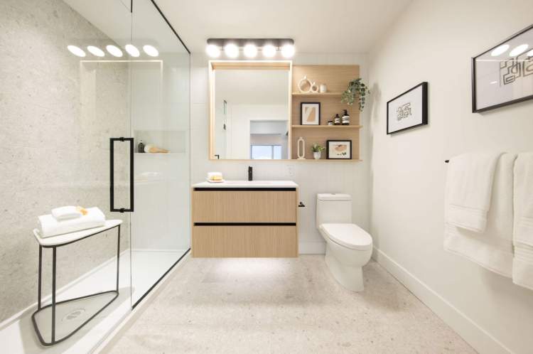 Floating vanities, quartz countertops, and stunning feature wall.