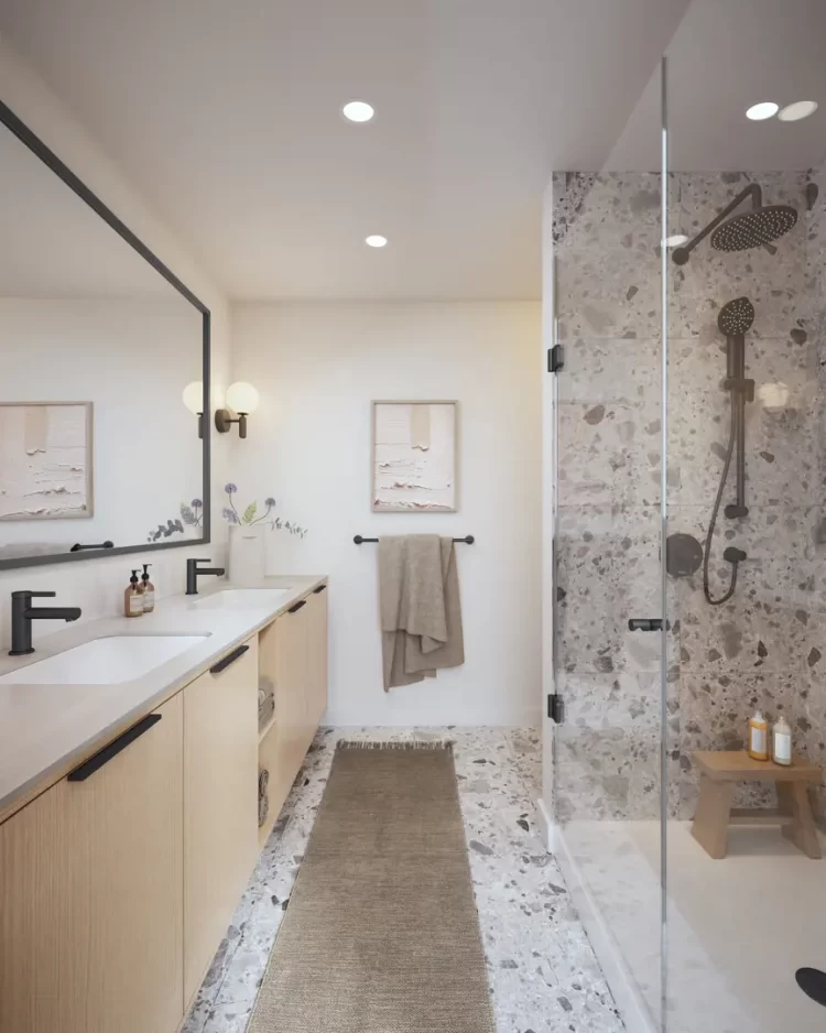 Features frameless shower with floor-to-ceiling terrazzo tiles.