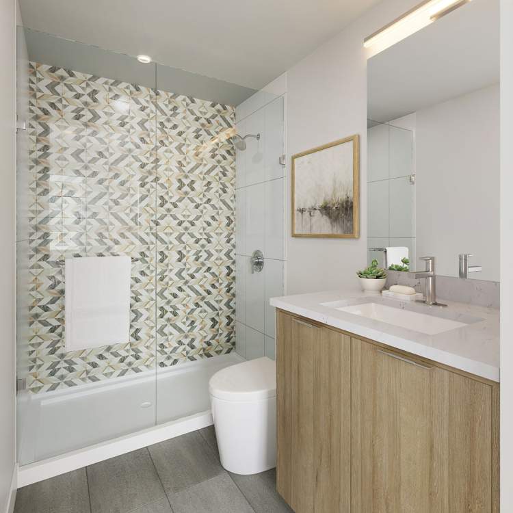 En suites boast chevron-patterned tile feature wall.