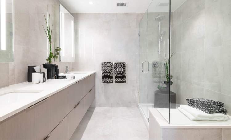 Talistar en suites feature hotel-inspired lighting and a frameless glass shower with bench seating.