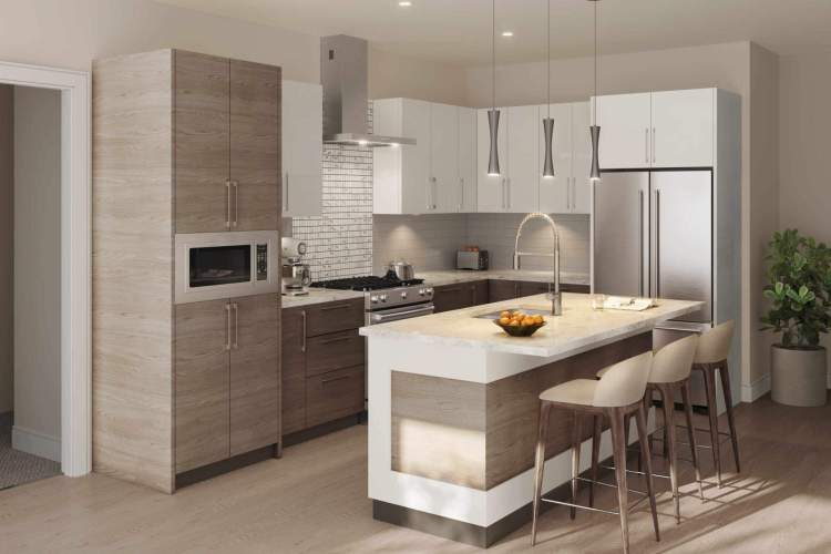 The Tides at Cordova Bay kitchen feature stainless steel KitchenAid appliances.