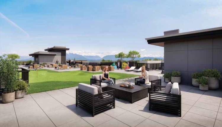 With a backdrop of distant mountains, The Commons rooftop amenity is an inviting gathering spot.