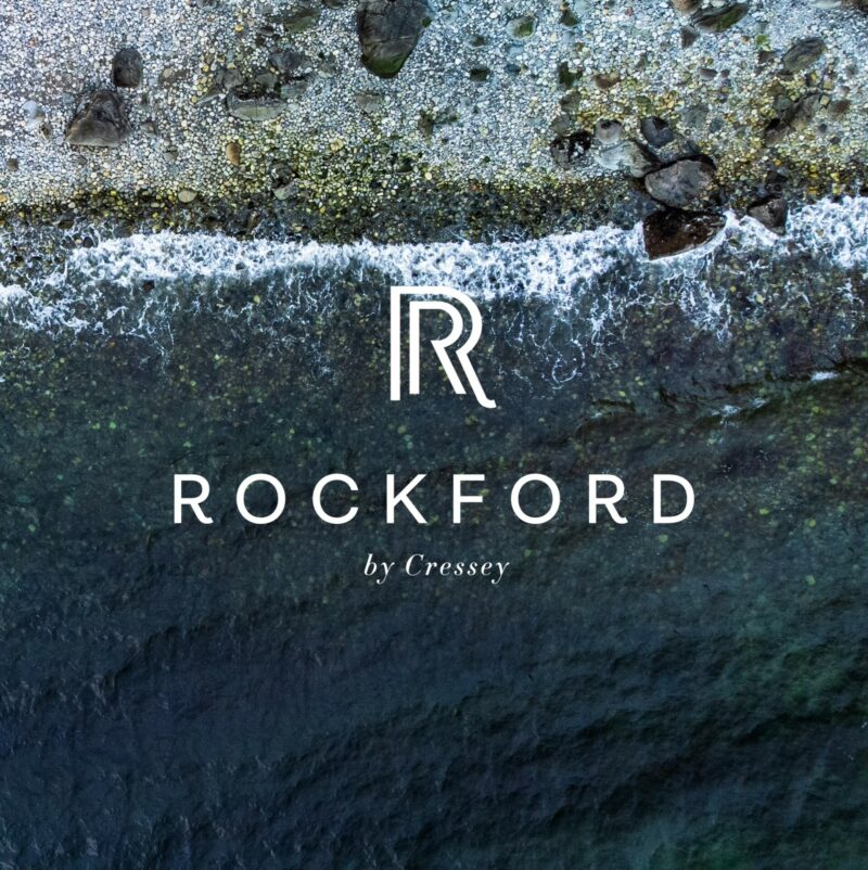 Rockford promo image showing ocean and rocky beach.